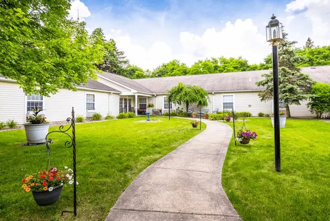 A serene house with a well-maintained garden and a winding pathway.