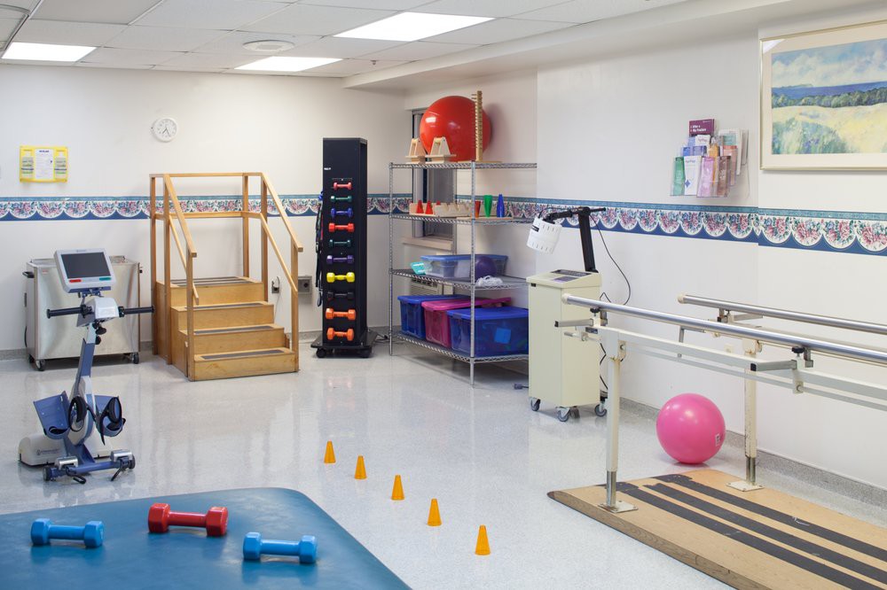 A physical therapy room with various exercise and rehabilitation equipment.