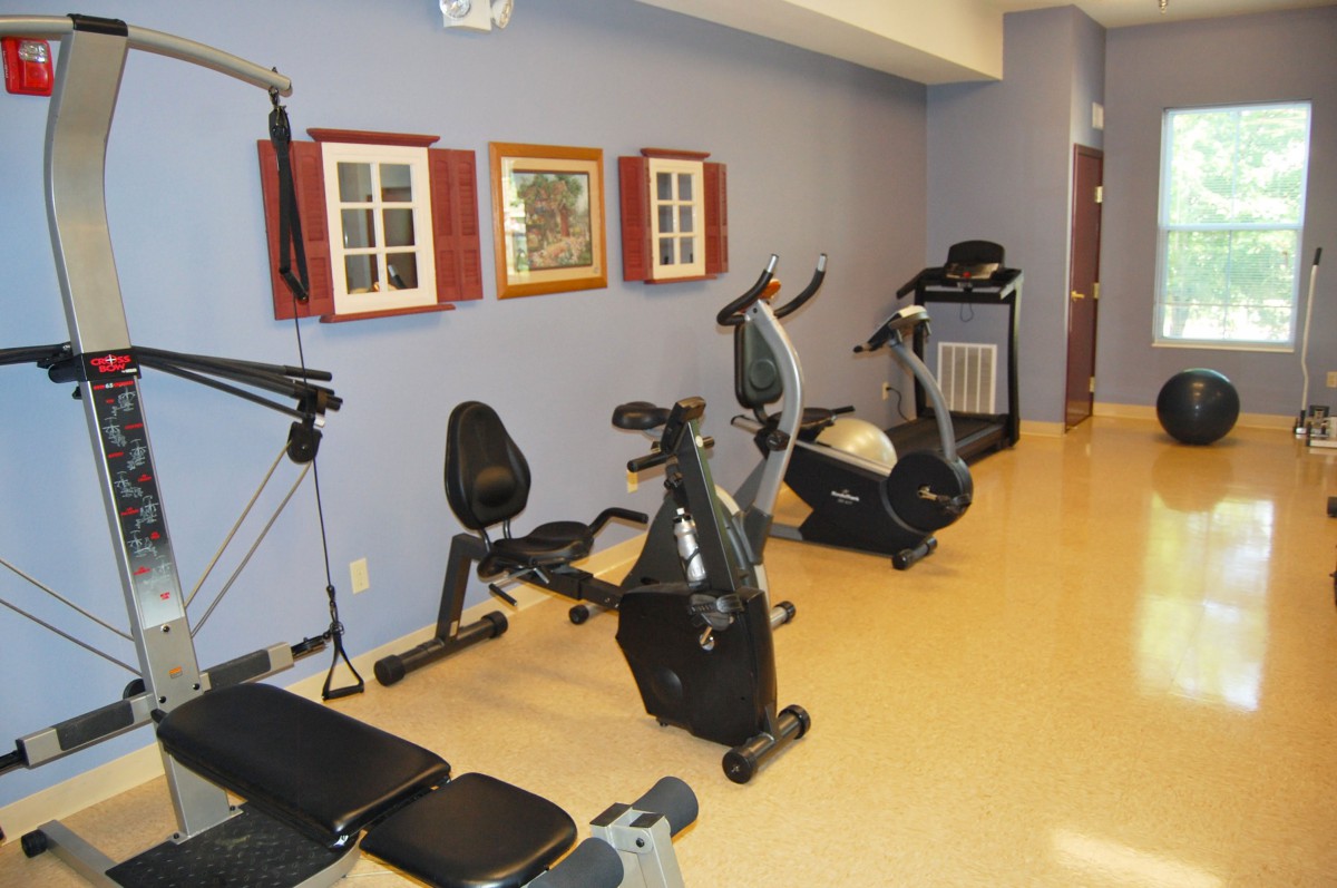 A small gym area with various exercise equipment including stationary bikes.