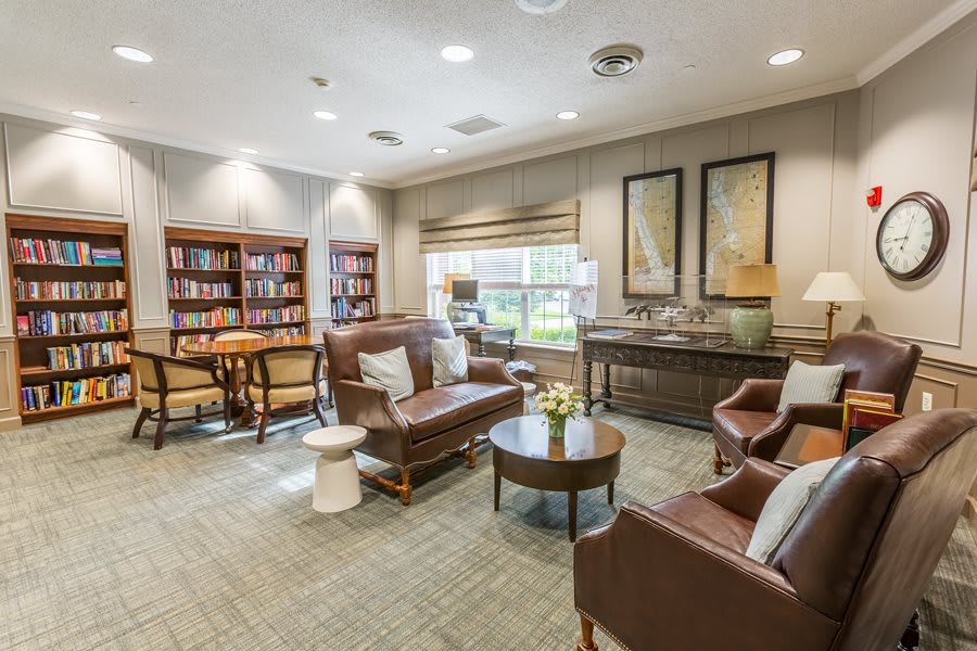 A cozy library interior with comfortable seating and well-stocked bookshelves.