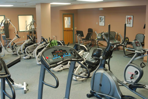 A view of a fitness gym featuring various exercise equipment.