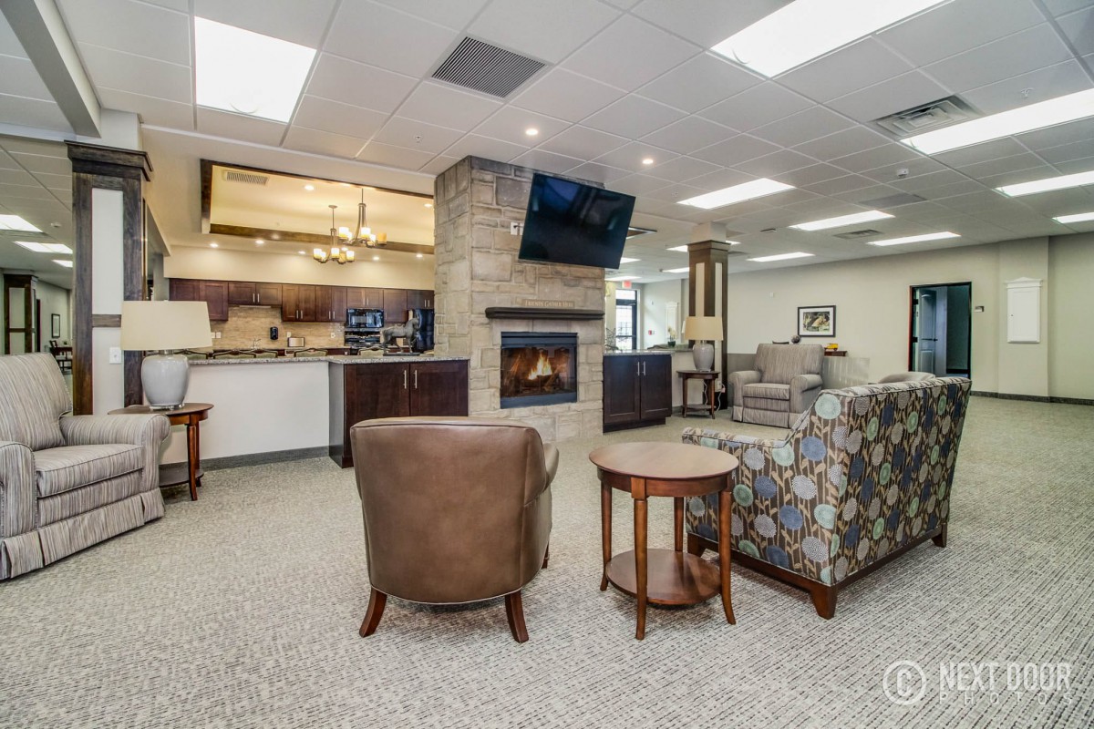 Spacious living area with a fireplace and open kitchen layout.