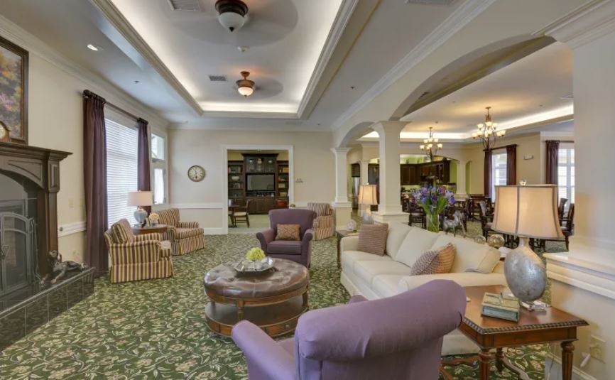 A cozy and elegant living room with comfortable seating and warm lighting.