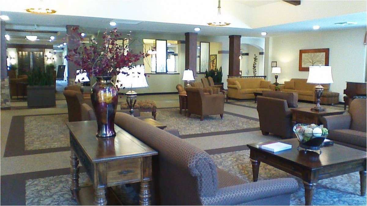 A spacious and well-furnished lobby area with sofas, chairs, and decorative elements.