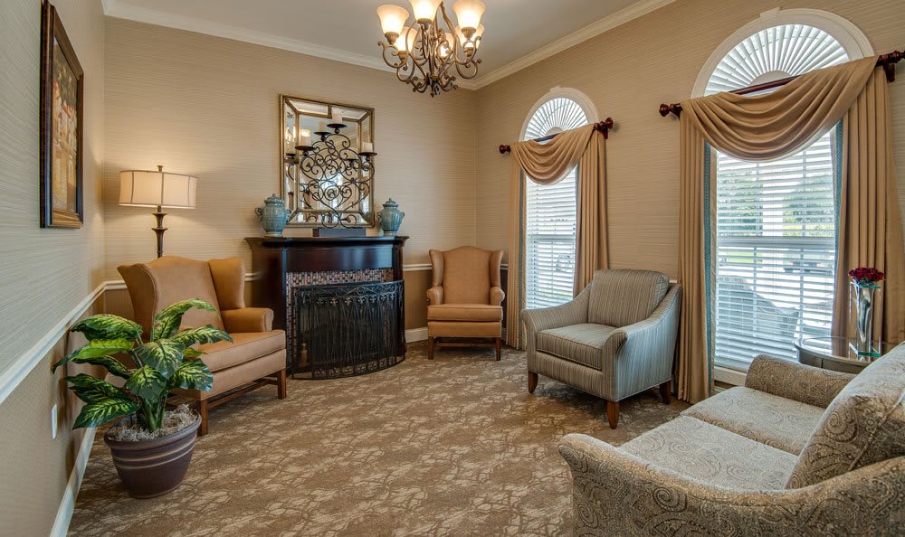 A cozy living room featuring elegant furnishings and a chandelier.
