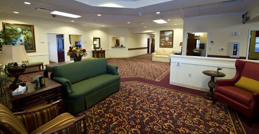 A spacious lobby with comfortable seating and a patterned carpet.