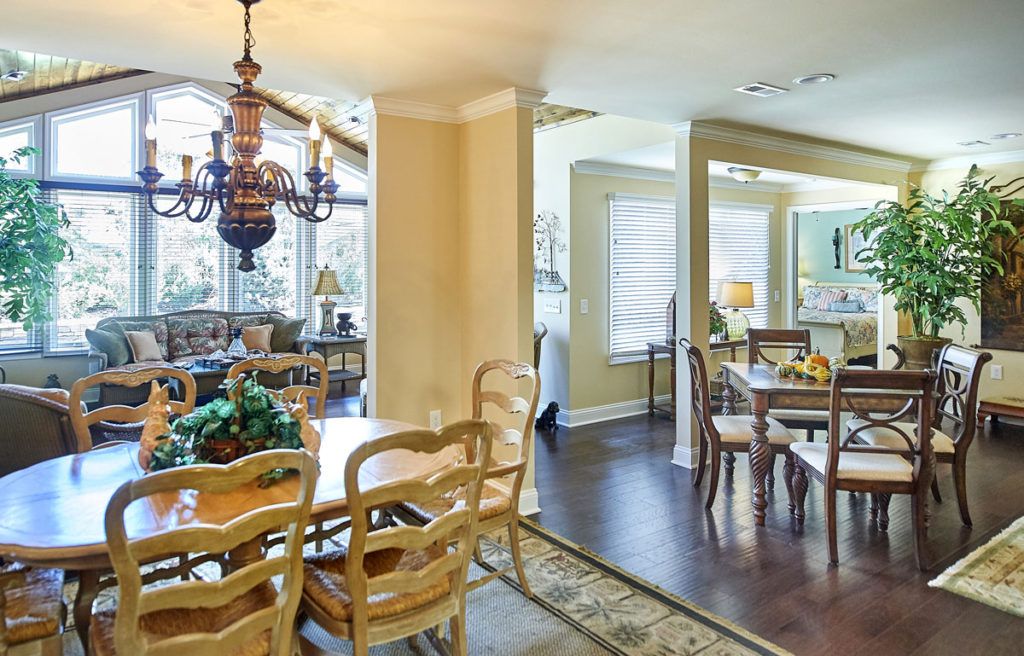 A cozy dining area with elegant wooden furniture and a vintage chandelier.