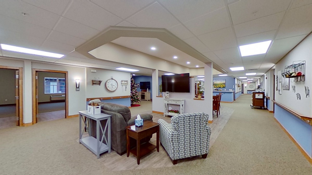 A cozy living room with comfortable seating and a large television.