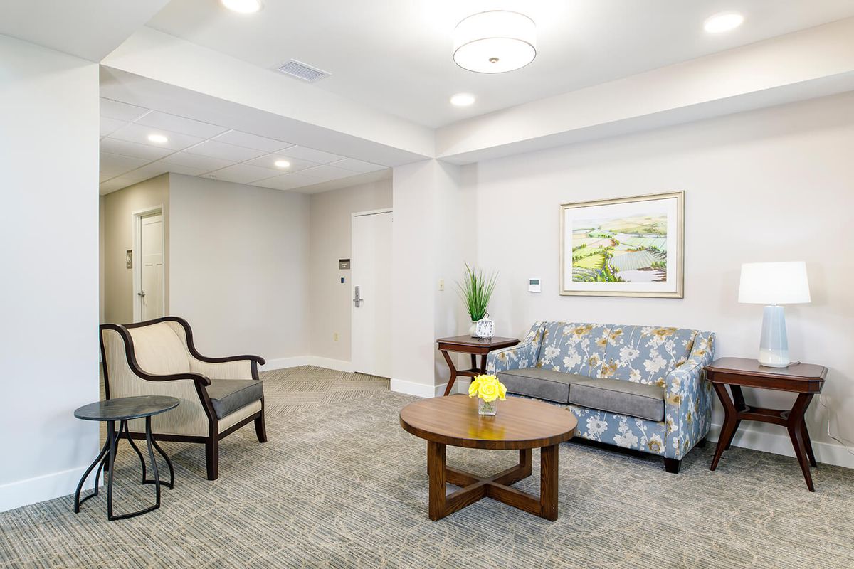 A well-lit living room with comfortable seating and tasteful decor.