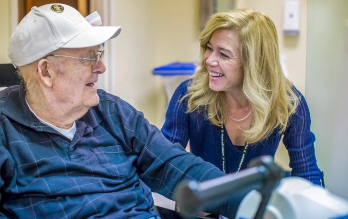 A woman sharing a joyful moment with an elderly man.