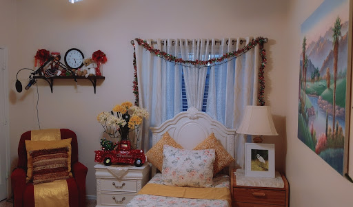 A cozy bedroom showcasing warm decor with floral accents and a charming toy truck.