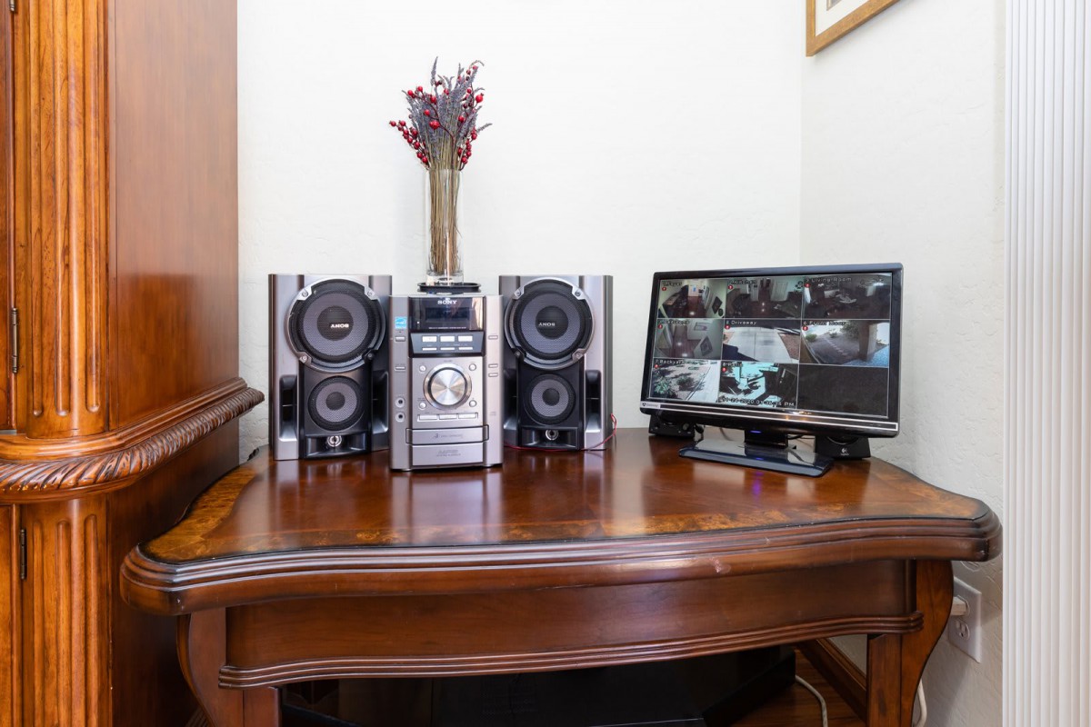 A stereo system with speakers and a computer monitor on a wooden desk.