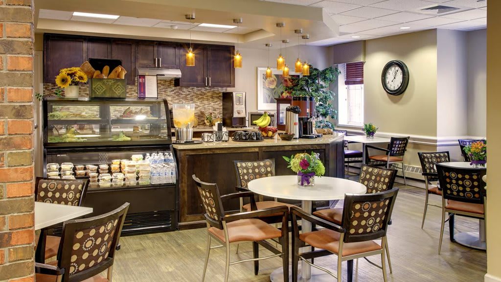 A cozy cafe interior with a coffee counter and seating area.