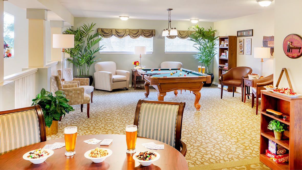 A cozy lounge with a pool table, comfortable seating, and elegant decor.