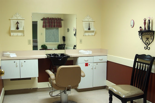 A cozy salon workstation featuring a styling chair, mirror, and essential tools for hair care.