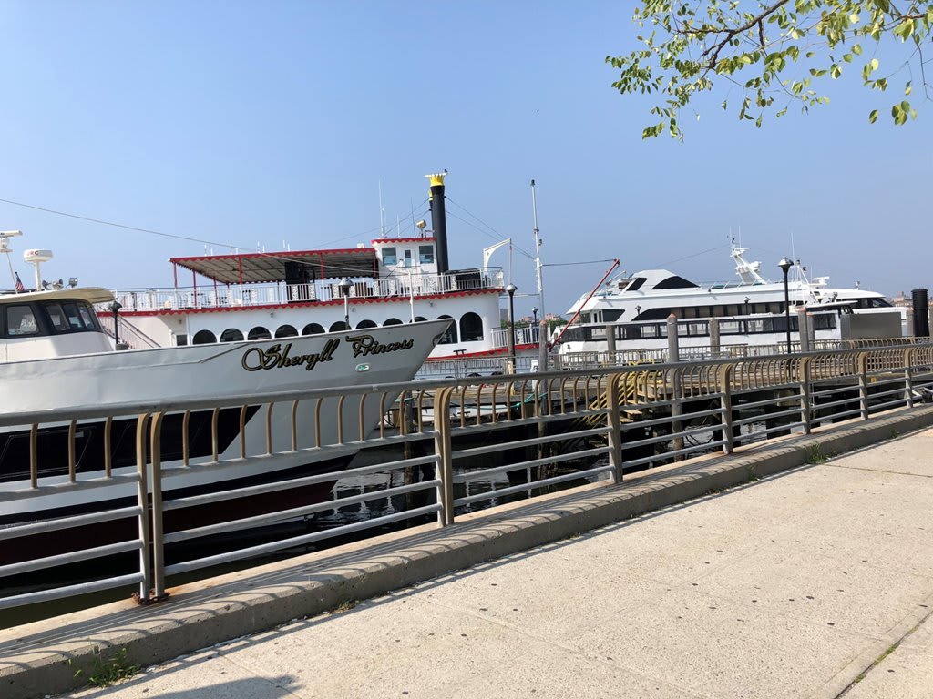 Boats docked at a riverside on a clear day.