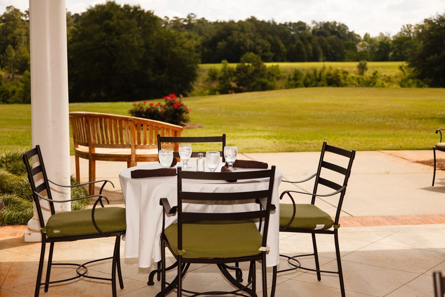 A serene outdoor dining setup with a picturesque view of lush greenery.