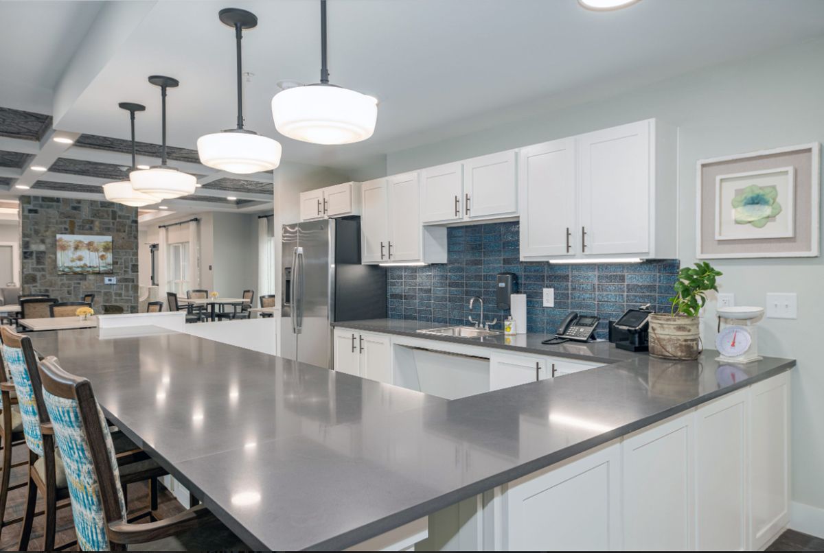 A modern kitchen with sleek countertops and contemporary lighting.