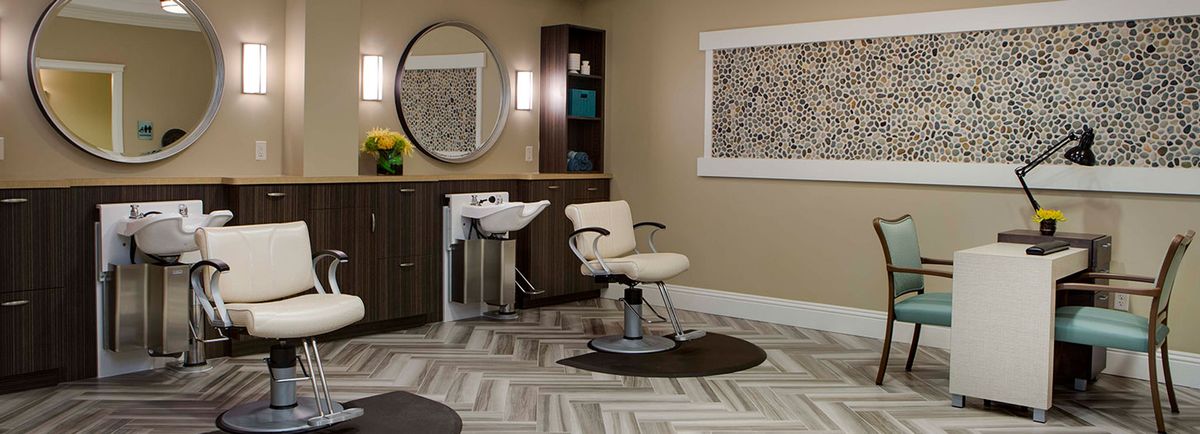 A modern salon interior with a hairdressing chair and mirror.