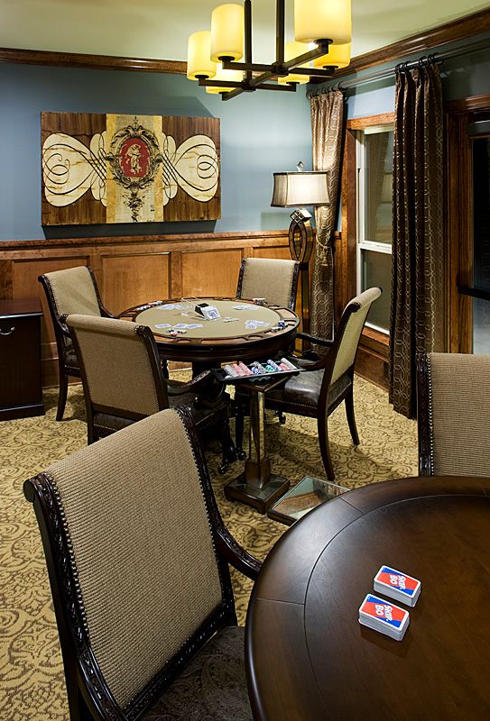 A cozy gaming room featuring a poker table and comfortable seating.