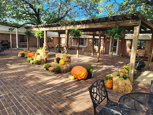 A charming outdoor space adorned with vibrant pumpkins and bales of hay, celebrating the beauty of autumn.