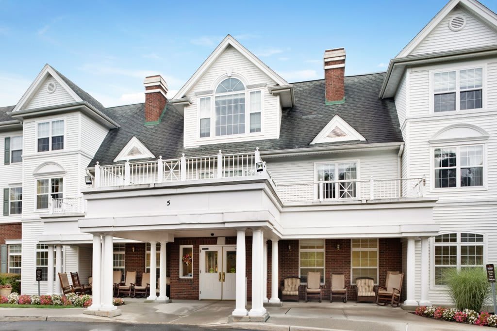 A large house with white columns and a porch.