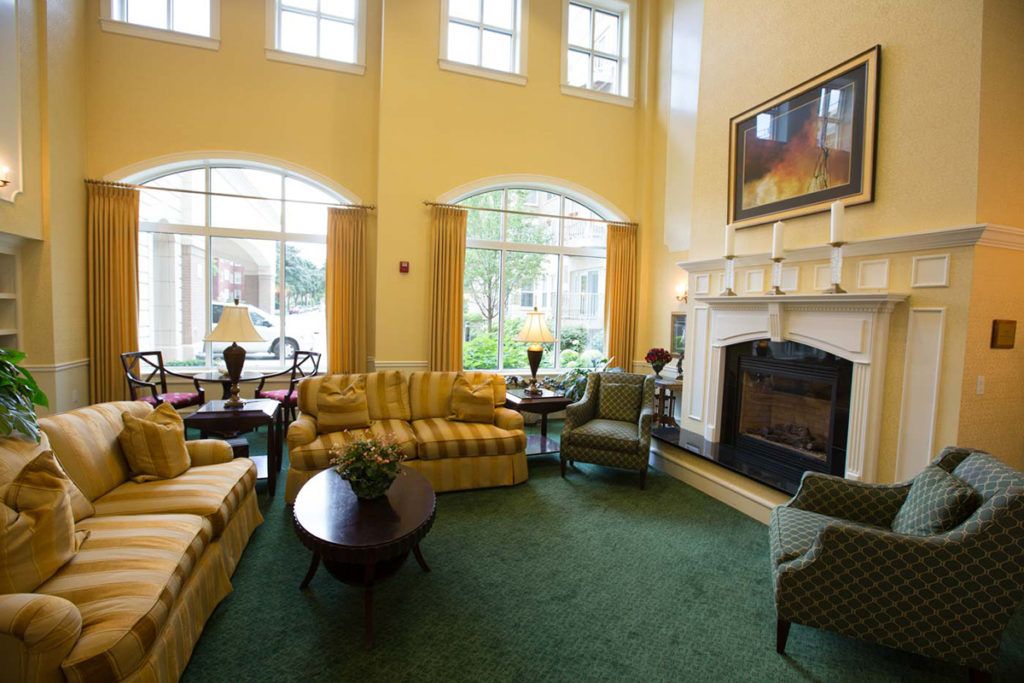 A cozy living room with comfortable seating and a large fireplace.