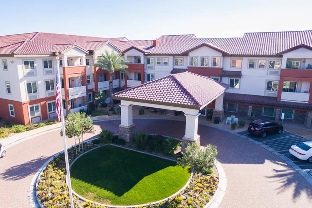 Aerial view of a large residential building with landscaped gardens and a main entrance.