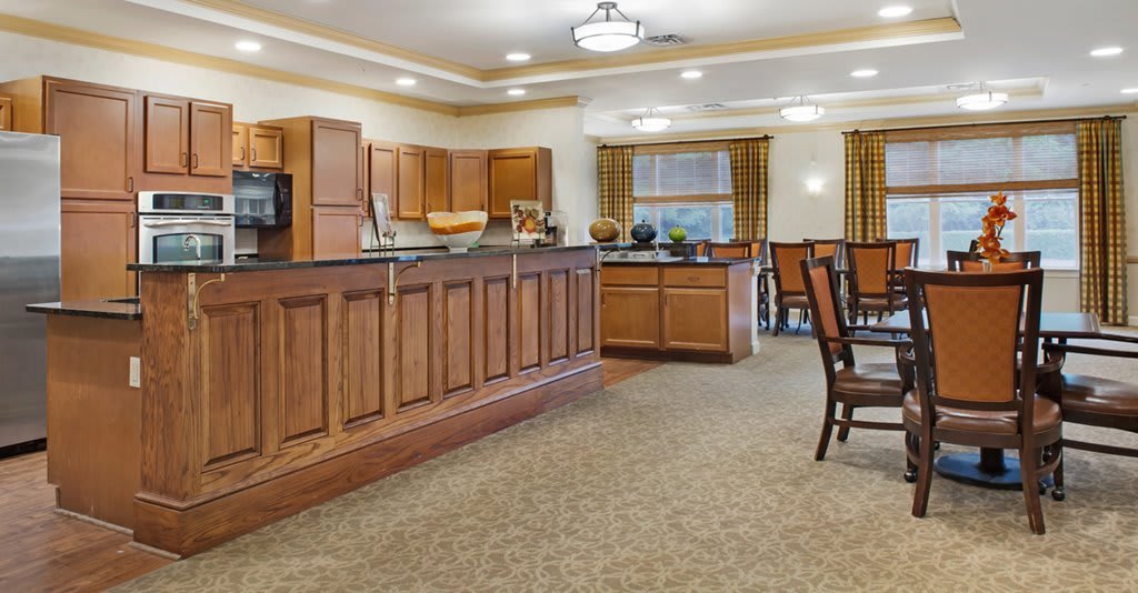 Spacious kitchen and dining area with wooden cabinets and warm lighting.