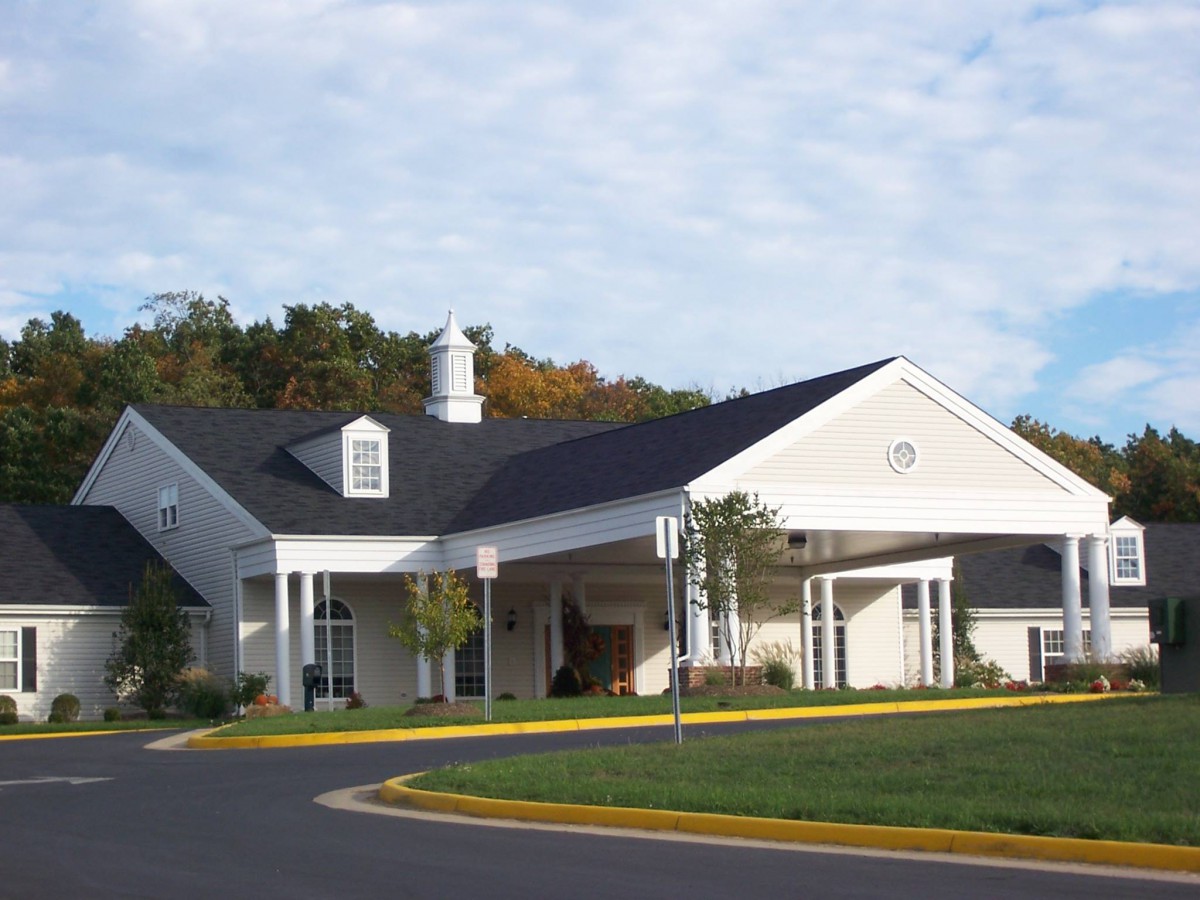 A suburban residential building with a well-maintained exterior and surrounding greenery.