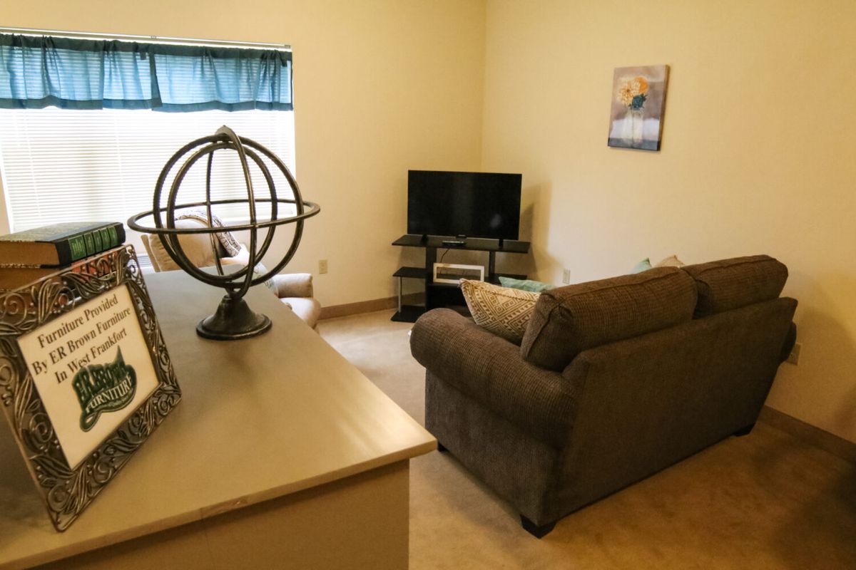 A cozy living room with a sofa and television setup.