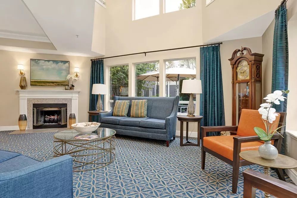 Spacious living room with elegant furniture and cozy fireplace.