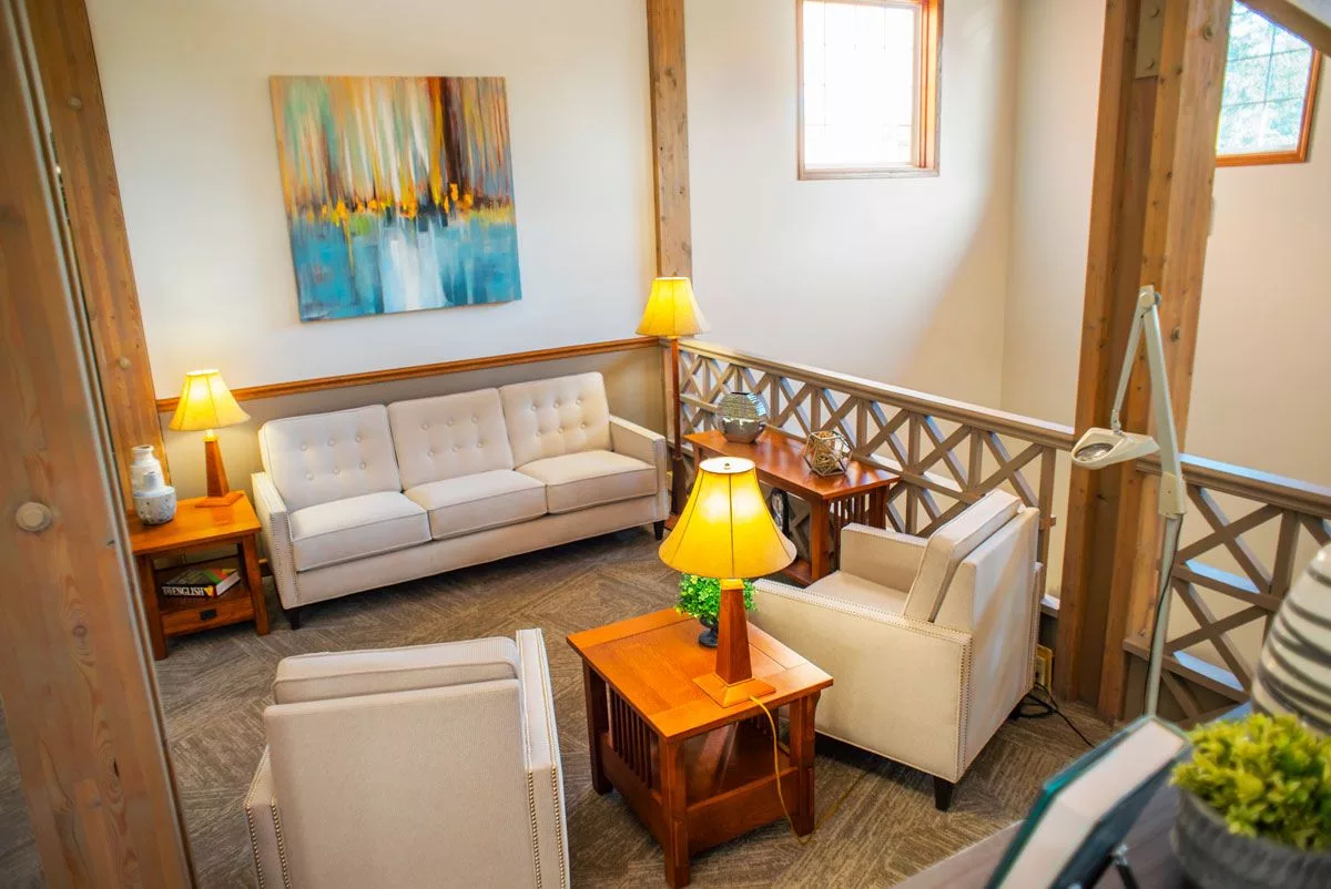 A cozy living room with stylish furniture and artwork on the wall.