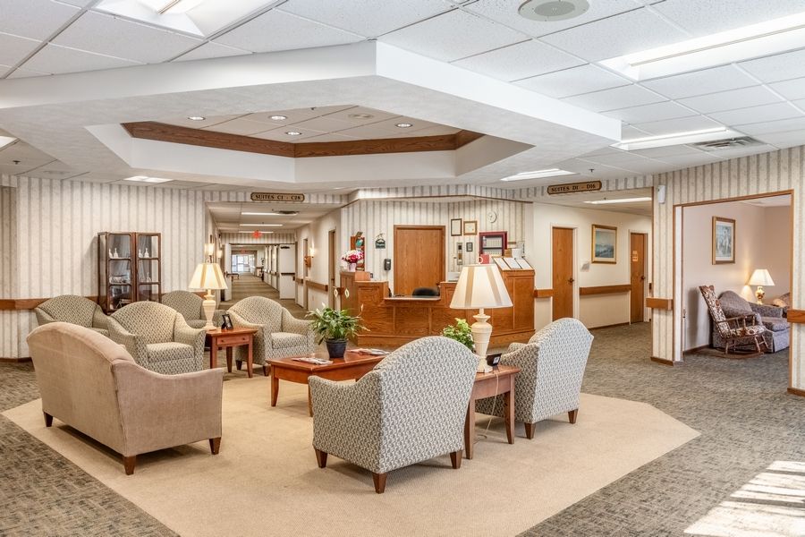 A spacious and well-lit lobby with comfortable seating areas and a reception desk.