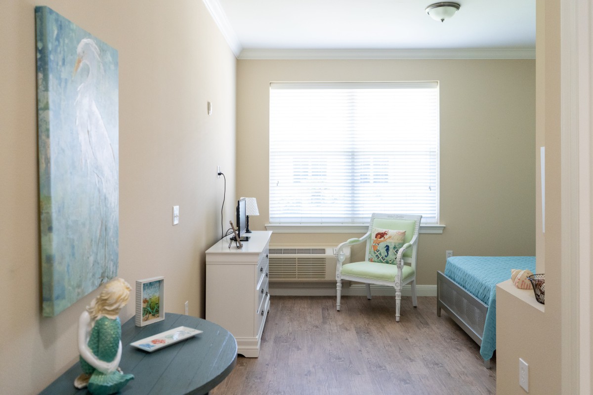 A minimalist bedroom with natural light, featuring simple furniture and a soothing color palette.