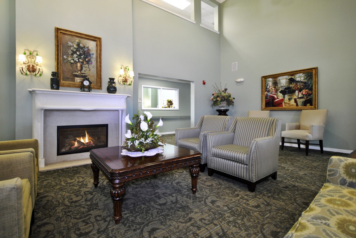 A cozy living room with a fireplace and comfortable seating arrangements.