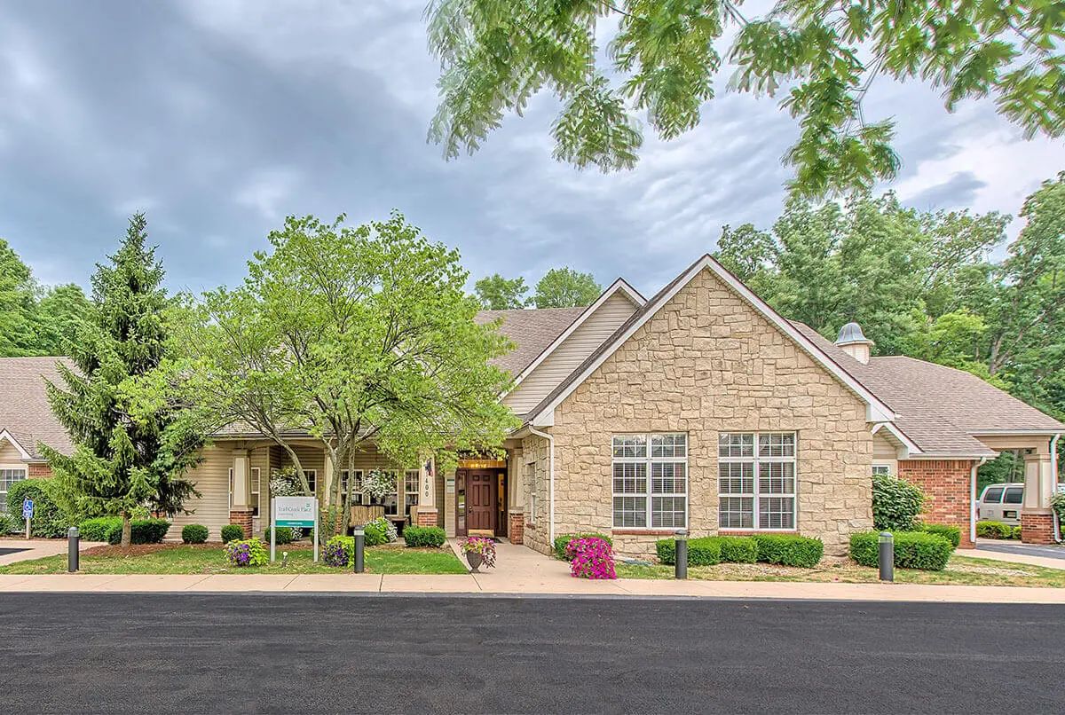 A suburban house with a brick exterior and a well-maintained front yard.