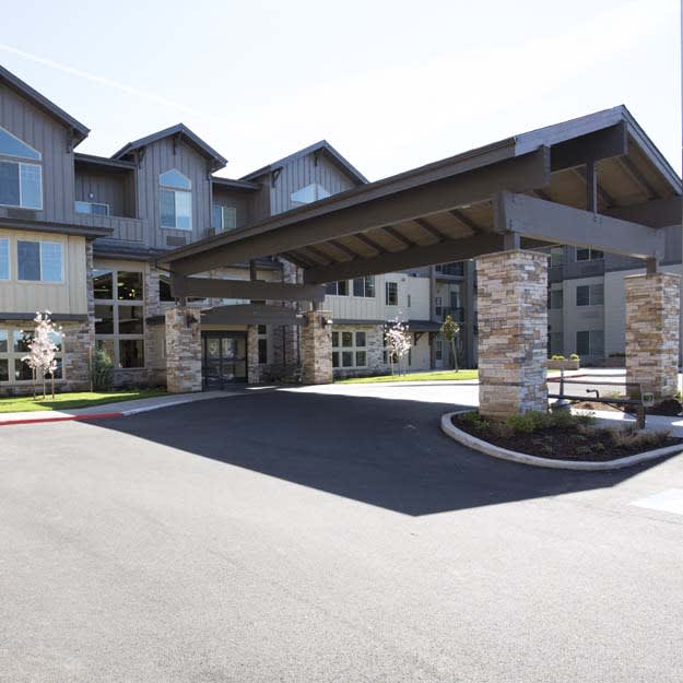A modern residential building with a covered entrance.