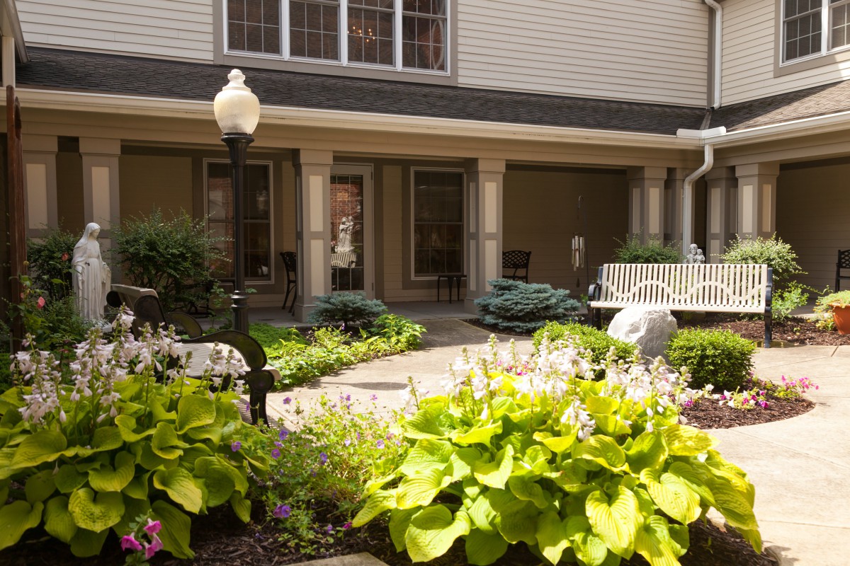 A well-maintained courtyard garden with lush greenery and seating areas.
