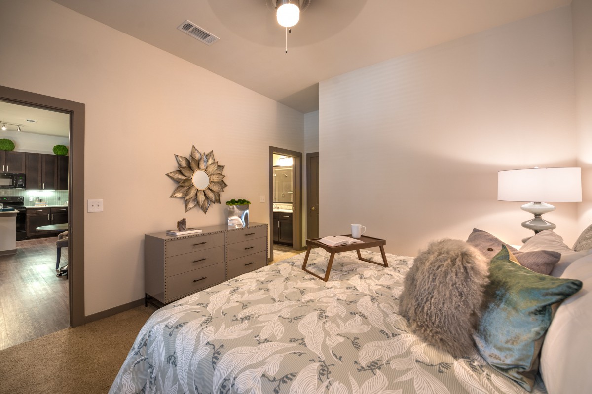 A modern bedroom featuring elegant decor with a stylish bedding arrangement and contemporary furniture.