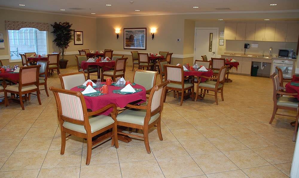 An empty dining room with tables set for guests.