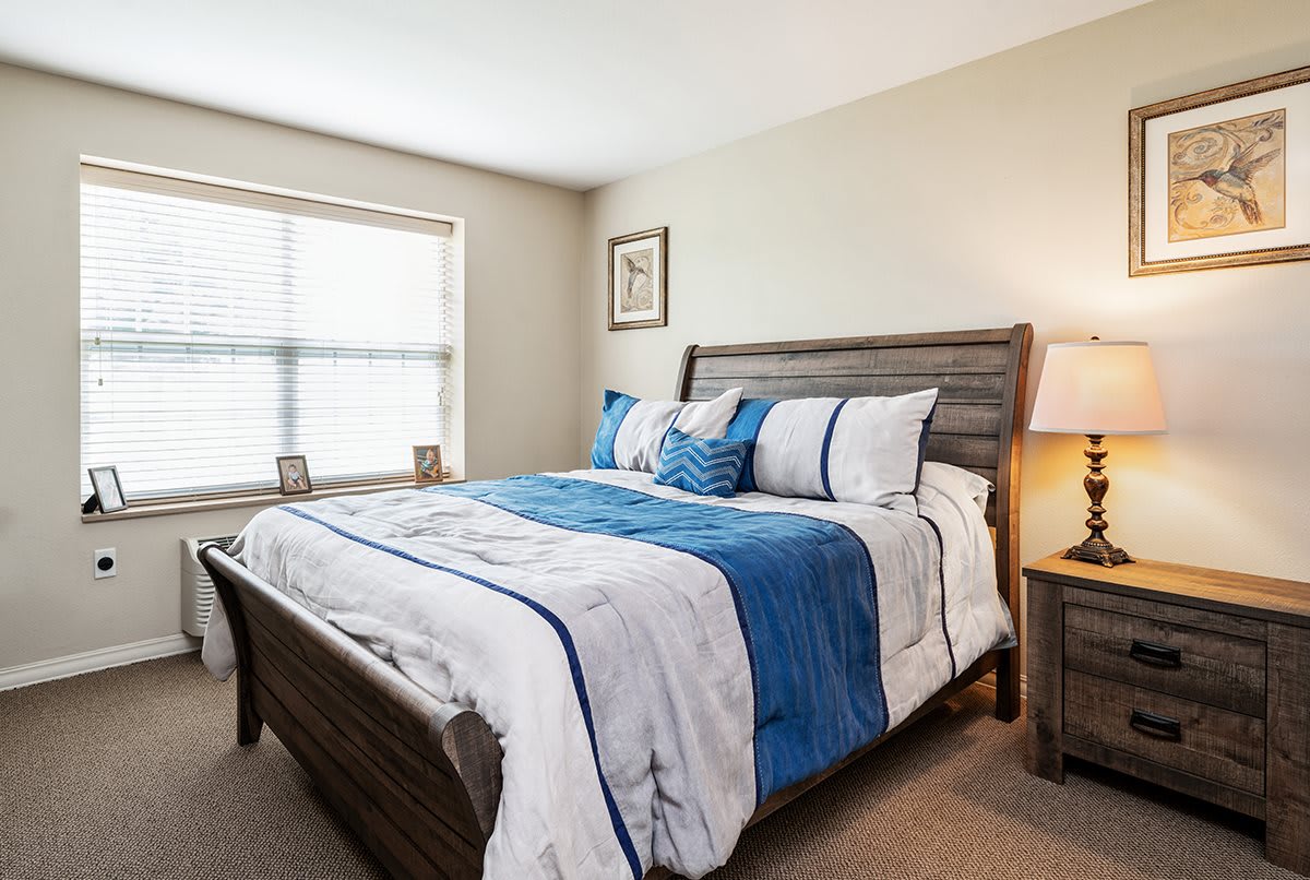 A cozy bedroom with a neatly made bed and elegant decor.