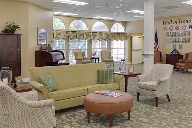 A cozy living room with comfortable seating, large windows, and elegant decor.