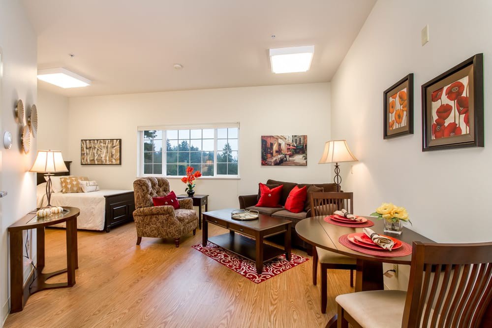 A cozy living room with elegant decor, featuring a comfortable sofa, armchair, and dining table.