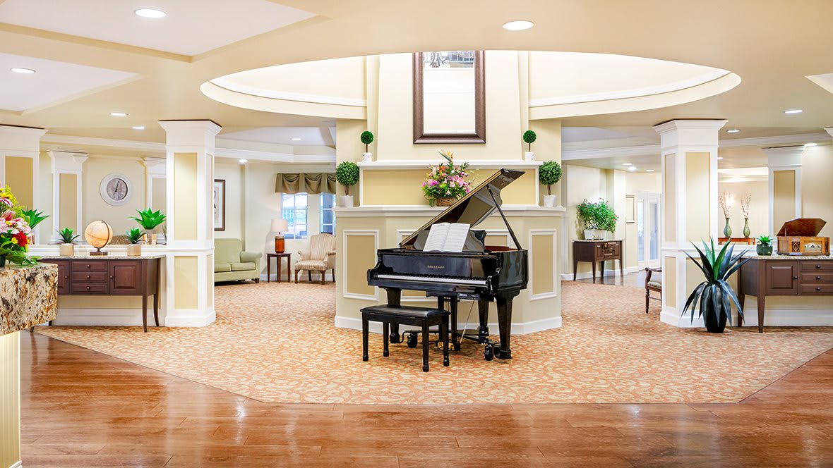 A beautifully decorated lobby featuring a grand piano and elegant furnishings.