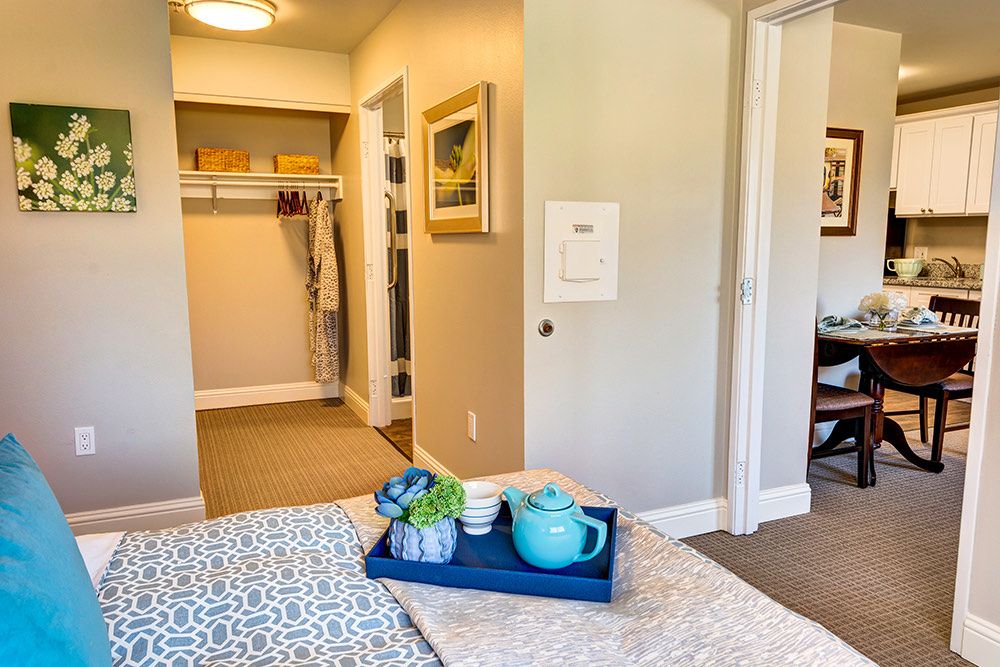 A cozy bedroom with a walk-in closet, featuring a tray with a teapot for added comfort.