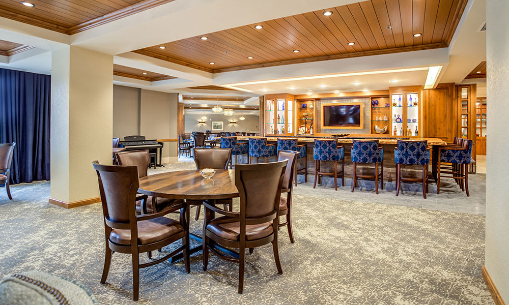 Upscale restaurant interior with a bar and seating area.
