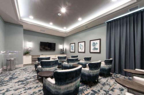 A modern conference room with comfortable seating and a large television for presentations.