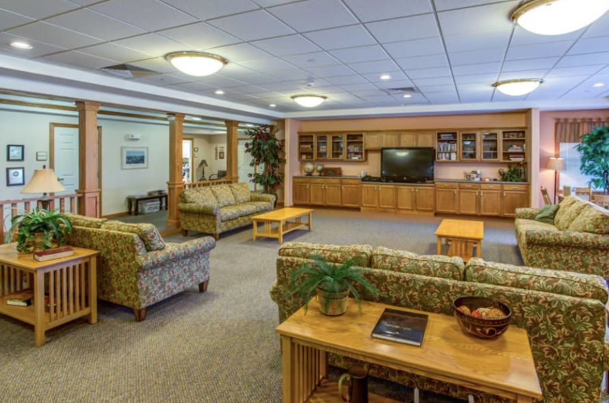 A cozy living room with comfortable seating, a television, and wooden furniture.