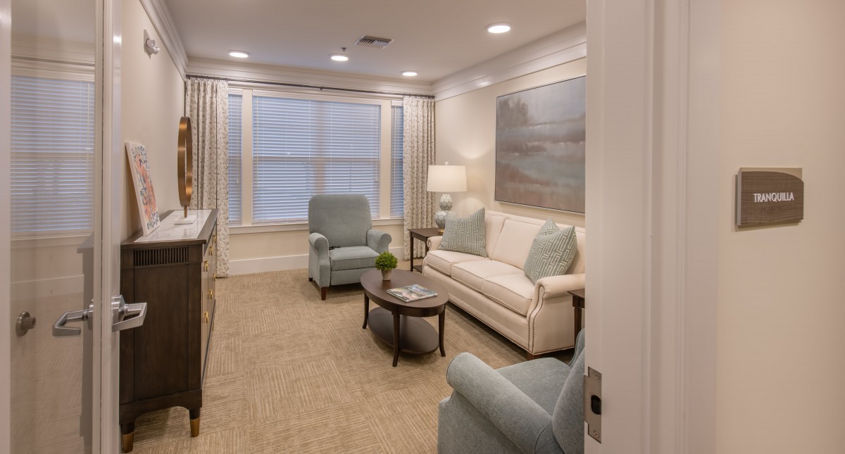 A cozy living room with a sofa, armchairs, and a coffee table.